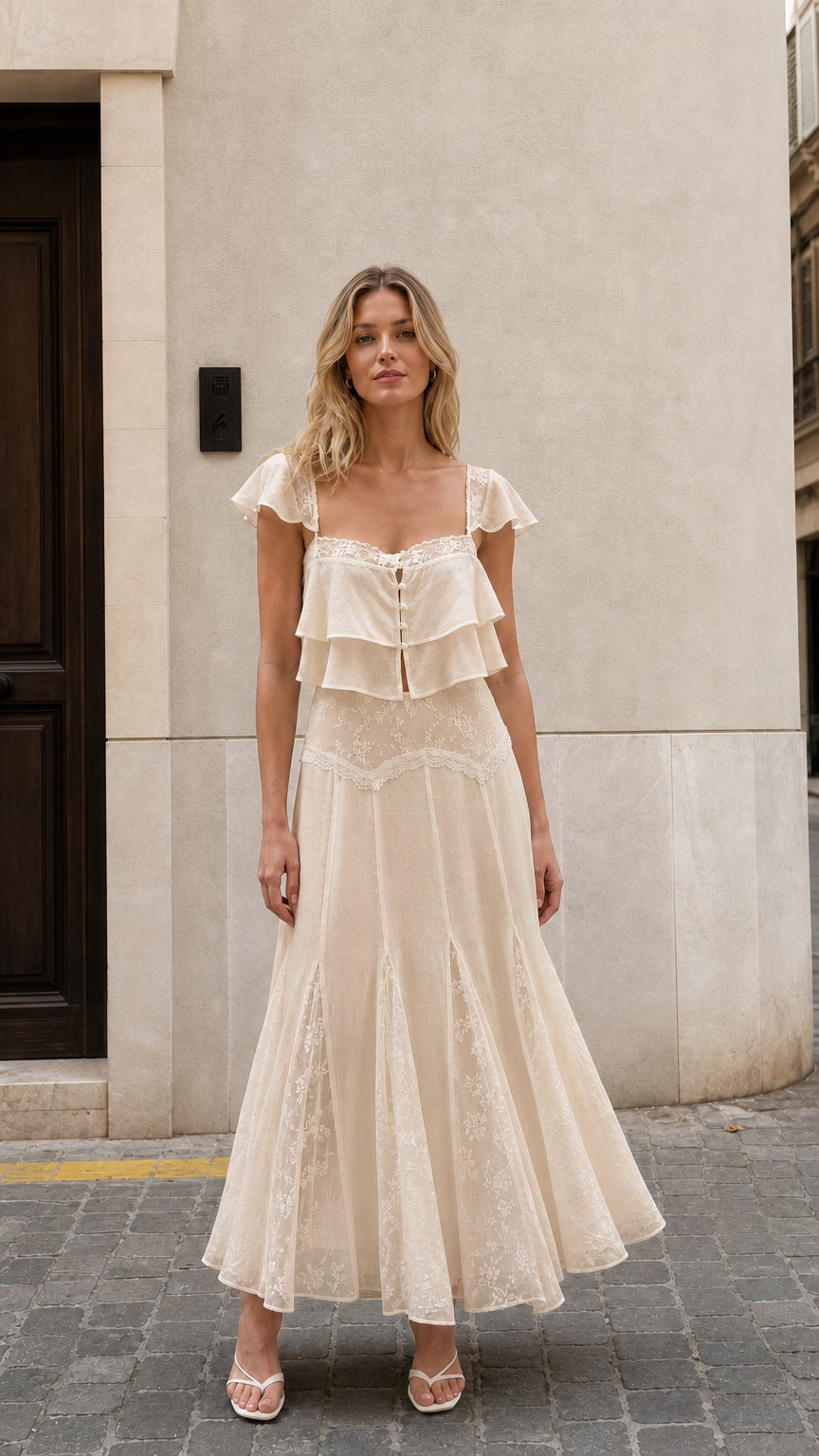 Front view of woman wearing beige ruffled two-piece maxi set
