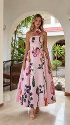 Model wearing pink floral strapless midi dress from the front
