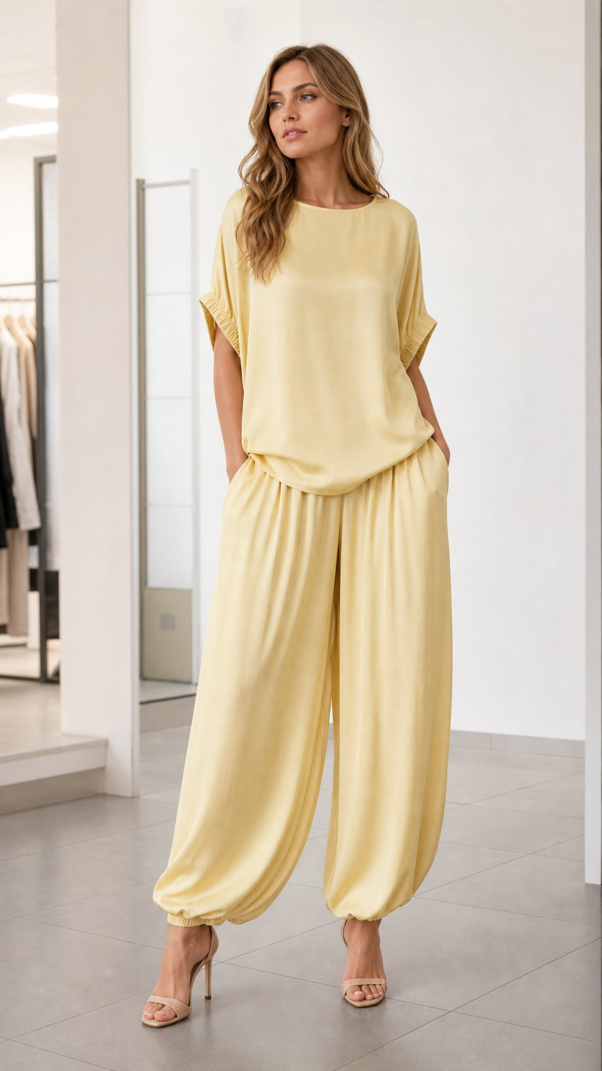Front view of model wearing yellow two-piece lounge set with harem pants