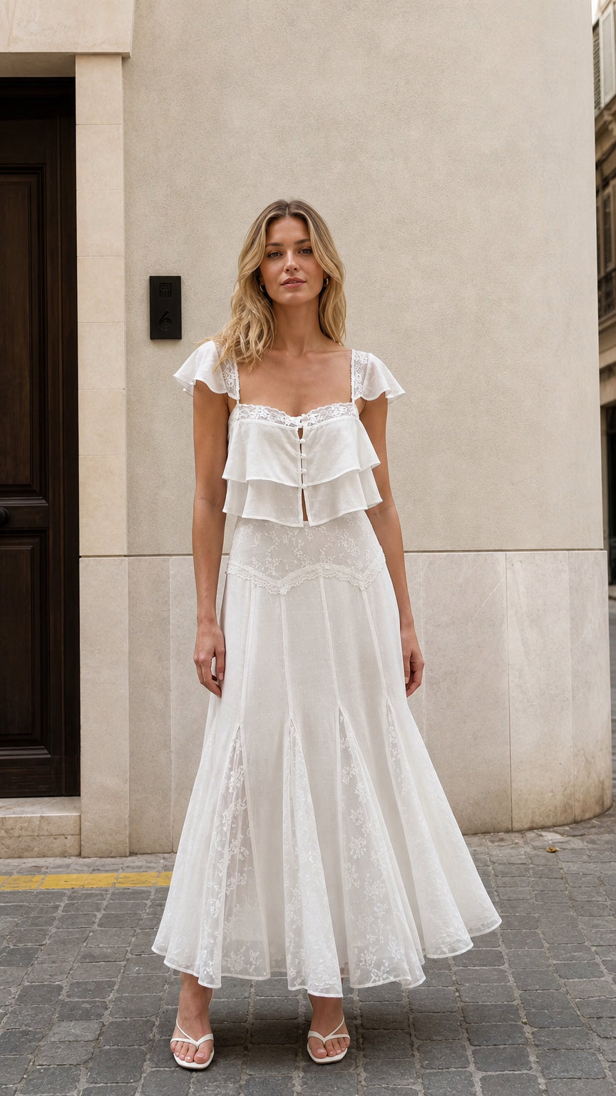 Front view of woman wearing white ruffled two-piece maxi set
