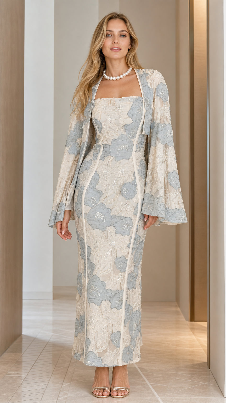 Front view of champagne floral embroidered maxi dress with matching capelet