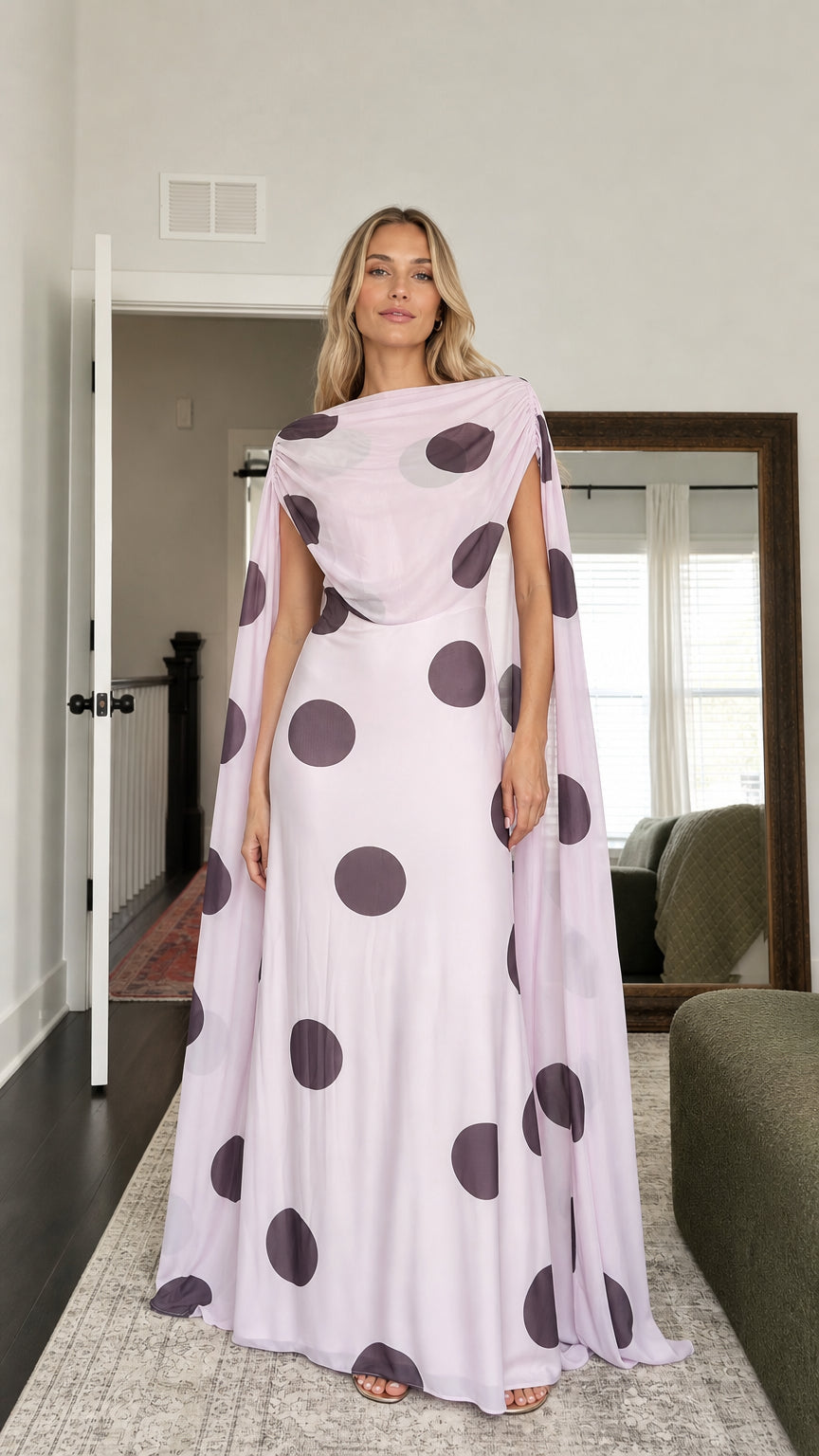 Model wearing lavender polka dot cape maxi dress from the front