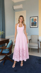 Front view of model wearing pink halter neck long dress