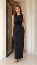 Front view of model wearing black pinstripe vest and maxi skirt set