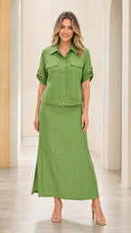 Front view of woman wearing green two-piece shirt and maxi skirt set
