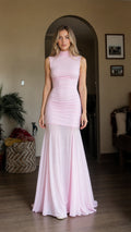 Front view of model wearing pink high neck ruched maxi dress