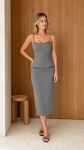 Model wearing grey houndstooth cami and midi skirt set from front view