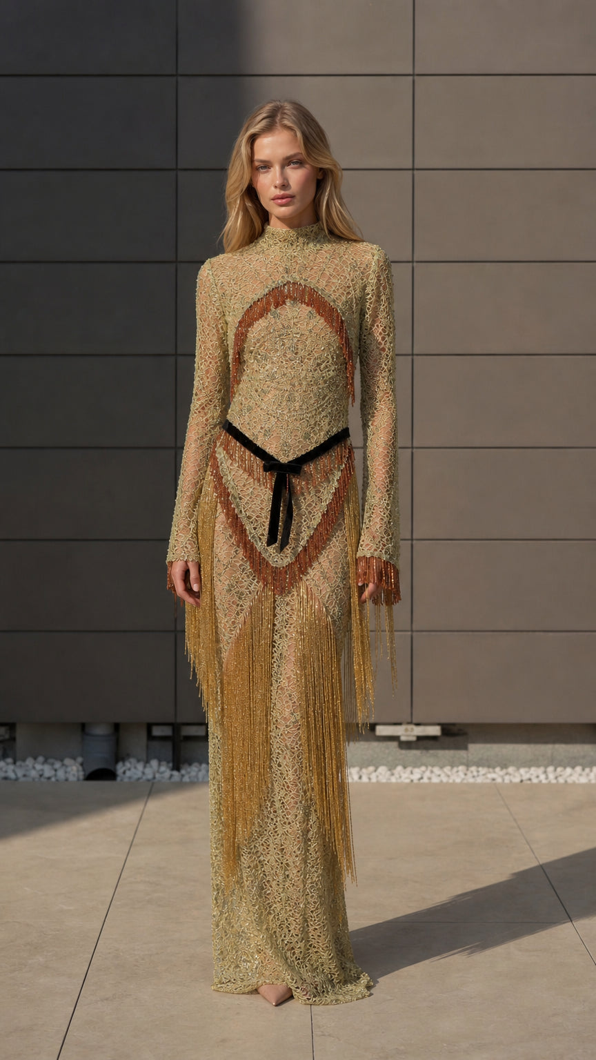 Front view of model wearing gold metallic crochet fringe maxi dress
