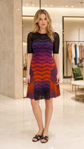 Front view of model wearing multi-color ombre chevron knit dress