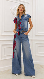 Front view of model wearing blue embroidered denim vest and wide-leg pants set