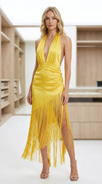 Front view of model wearing yellow satin halter fringe midi dress