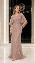 Front view of woman wearing champagne beaded floor-length evening gown