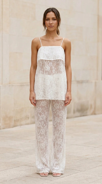 Front view of model wearing white lace cami and wide leg pants