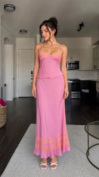 Model wearing pink lace trim satin camisole and maxi skirt set from front