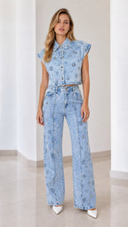 Front view of model wearing light blue embellished denim vest and matching wide-leg pants