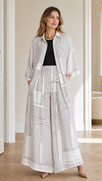 Front view of model wearing white geometric print two-piece set