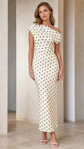 Front view of model wearing cream polka dot one-shoulder midi dress
