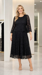 Front view of woman wearing black lace midi dress