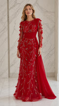 Front view of the red embellished long sleeve evening gown with drape train