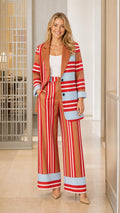 Front view of woman wearing brown striped blazer and wide-leg pants set