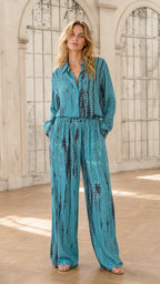 Front view of model wearing teal tie-dye jumpsuit