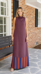 Front view of woman wearing navy and rust striped maxi dress