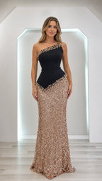 Model wearing black and gold one-shoulder sequin evening dress, front view