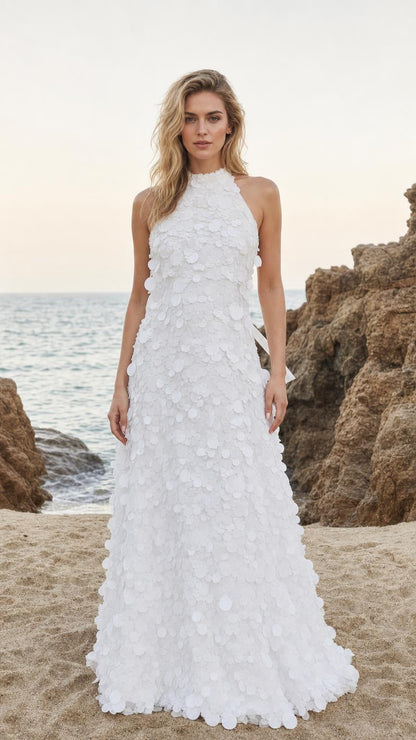 Front view of White halter neck 3D floral applique maxi dress on a beach