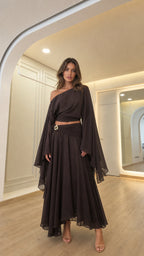Front view of woman wearing dark brown off-shoulder crop top and matching maxi skirt set