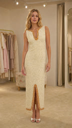 Front view of woman wearing cream beaded V-neck midi dress