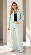 Model wearing mint green crop jacket and matching pants front view