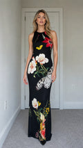 Model wearing black floral butterfly print sleeveless maxi dress from the front