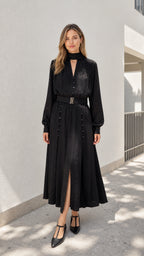 Model wearing black mock neck belted midi dress from the front
