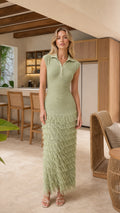 Model wearing sage green sleeveless knit polo maxi dress with fringe hem, front view