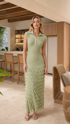 Model wearing sage green sleeveless knit polo maxi dress with fringe hem, front view