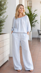 Front view of woman wearing light blue two-piece wide leg pant set