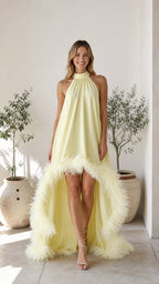 Front view of yellow high-neck feather hem maxi dress