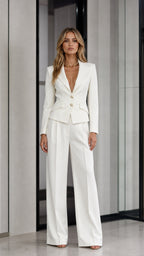 Front view of woman wearing a white tailored blazer and wide leg pants suit
