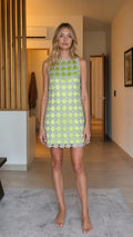Front view of model wearing lime green beaded mini shift dress