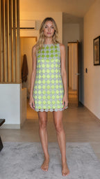Front view of model wearing lime green beaded mini shift dress
