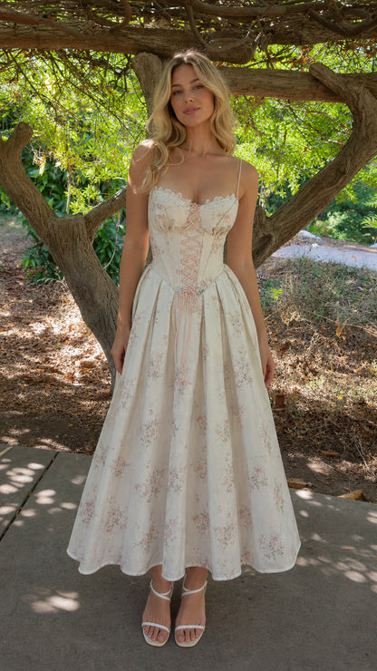Full length view of woman wearing white floral corset midi dress outdoors