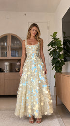 Front view of model wearing champagne sequin maxi dress