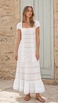 Front view of woman wearing white lace maxi dress