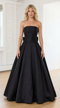 Front view of model wearing black strapless evening gown