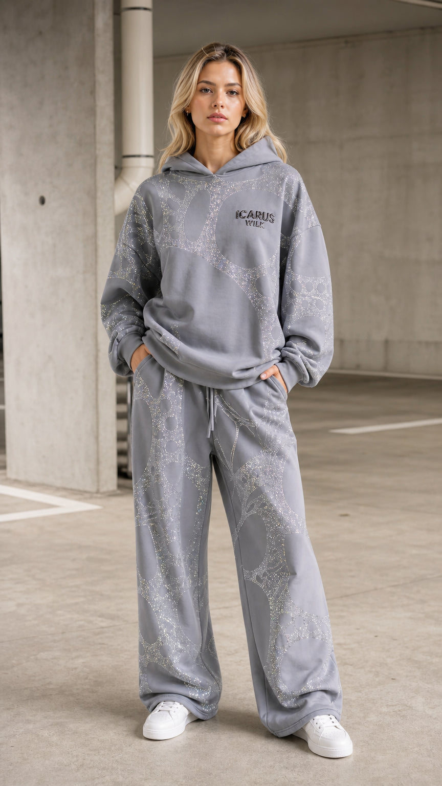 Front view of model wearing grey rhinestone hoodie and wide leg pants set