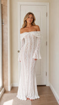 Full front view of a woman wearing a white off-shoulder lace maxi dress