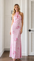 Front view of model wearing pink floral halter neck maxi dress