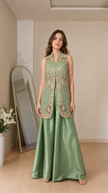 Front view of model wearing sage green embroidered vest and palazzo set