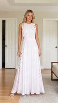Front view of woman wearing white cutout maxi dress