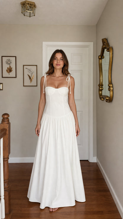 Front view of woman wearing white tie-strap corset maxi dress